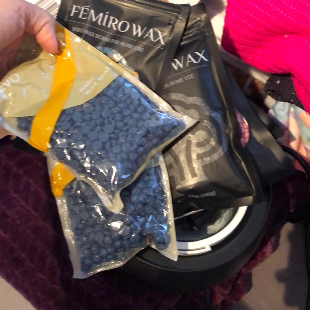 Used waxing kit with a full set of wax beads